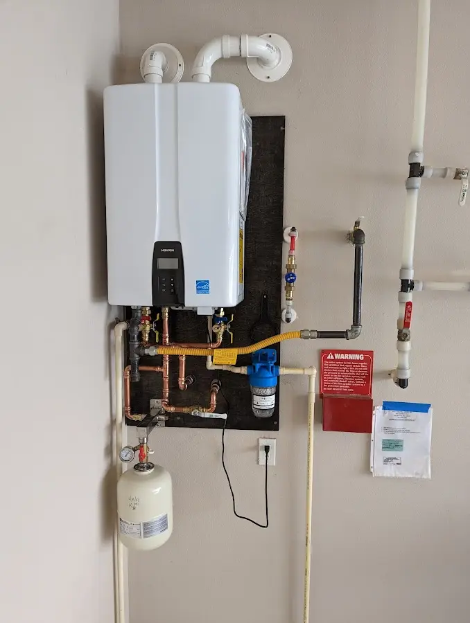 Professional plumber installing copper piping in a Valley home